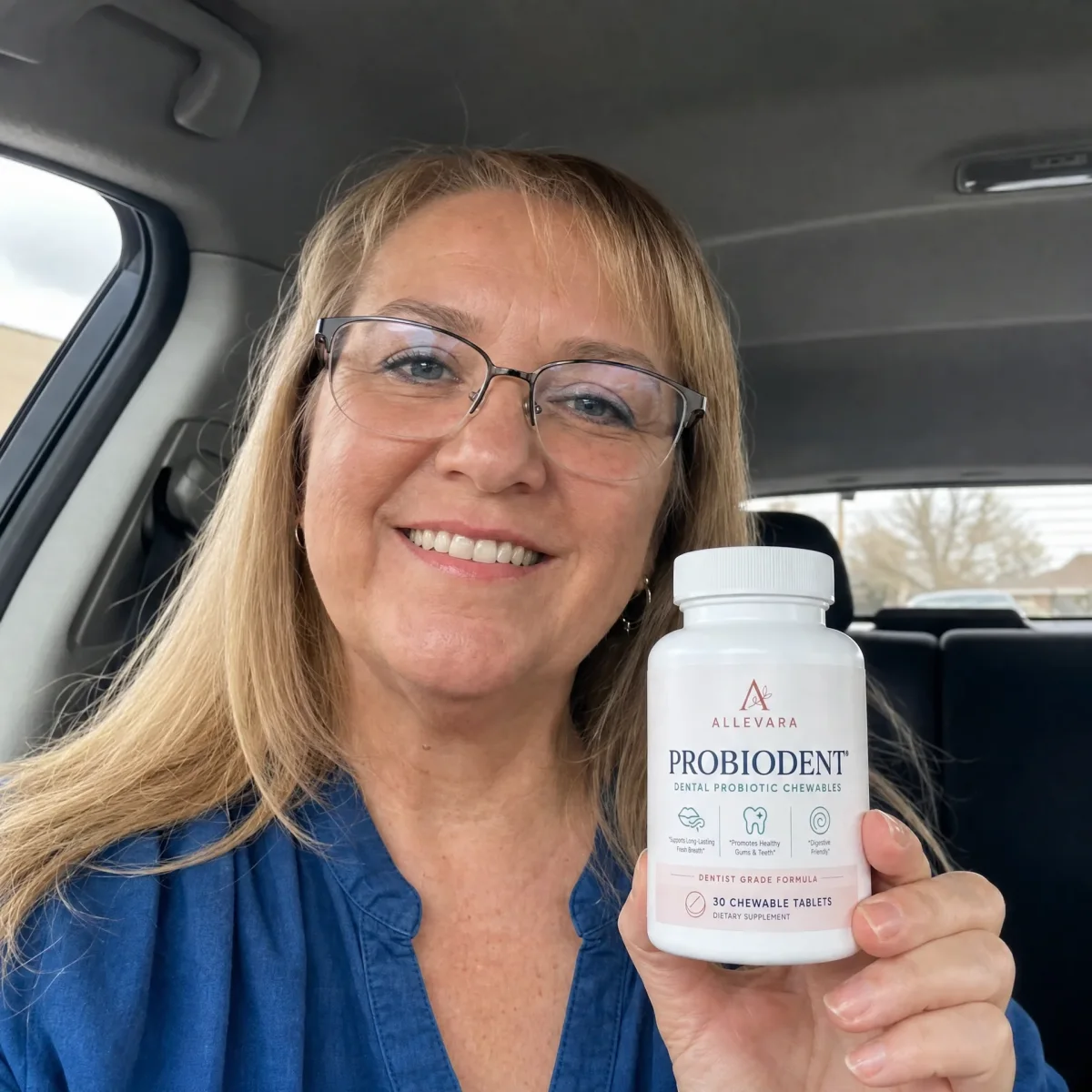 Woman smiling holding ProbioDent